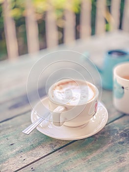 Close up white cup hot coffee on wood table