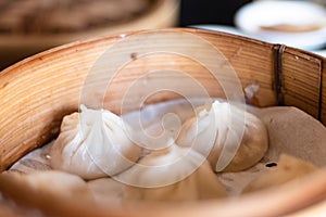 Close up white dim sum ha gow on wooden basket. traditional Cantonese dumpling