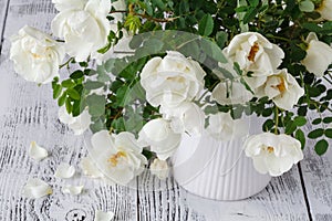 Close up of white flowers on wooden table.