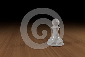 Close up of a white, glass, chess pawn on a wooden surface