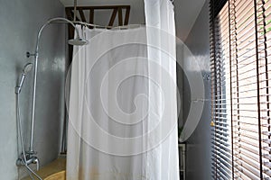 close up white hanging PVC strip curtain in hotel bathroom for shower
