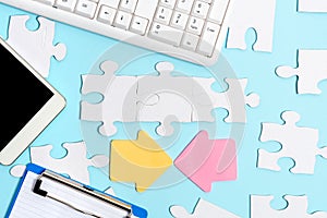 Close-Up White Jigsaw Pattern Puzzle Pieces To Be Connected With Missing Last Piece Positioned On A Flat Lay Background