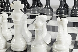 Close-up of white king on chess game opening. Marble board