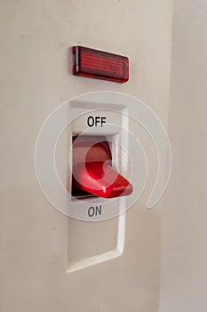 A close-up of a white light switch on a plain wall.