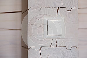 Close up white light switch on wooden wall