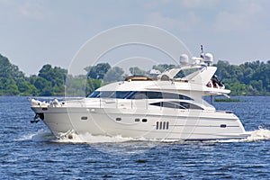 Close-up of white luxury yacht in motion on the Dniepr River, side view