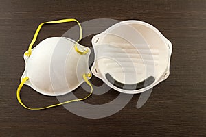 Close up of white mask stack on black wooden