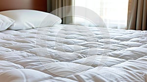 Close up of a white mattress protector on a well made bed for optimal search relevance photo