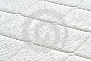 Close-up of white mattress texture.