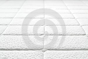 Close-up of white mattress texture.