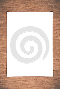 Close up White notebook paper on grunge wood background