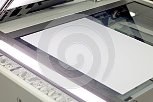 Close-up white paper sheets on the printer in office