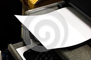 Close-up white paper sheets on the printer in office