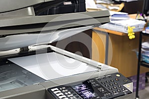 Close-up white paper sheets on the printer in office