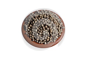 Close up of white pepper seeds in a clay pot in isolated background