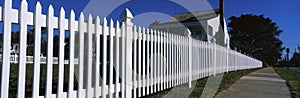 Close up of a white picket fence