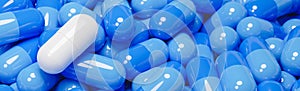 Close up of white pill capsule in many blue pills capsules. Medicine and Specialty Pharmaceuticals concept.,3d model and