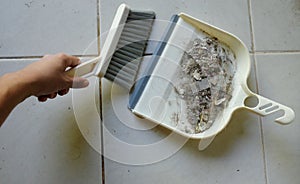 close up a white plastic whisk broom and dustpan indoors.concept Household hygiene