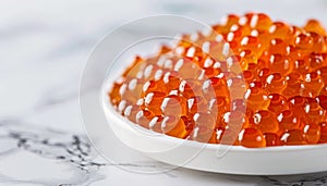 Close up of white plate with red caviar, offering ample space for accompanying text photo