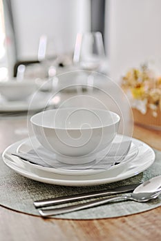 Close up white porcelain tableware plates on place mats