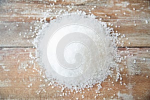 Close up of white salt heap on wooden table