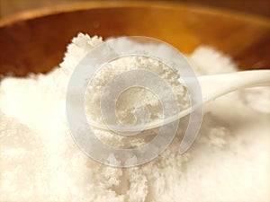 Close up white salt at white spoon