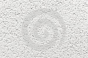 Close up of white seamless concrete pebble wall background or texture.