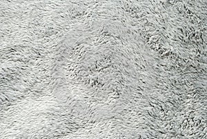 Close up white shaggy artificial fur texture or carpet for background