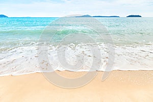 Close up white soft wave rolling splash on empty tropical sandy beach