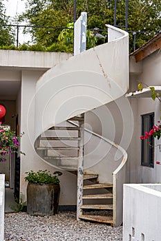 Close-up of white spiral staircase outdoors in villa