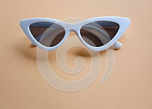 Close up white sunglasses isolate on a orange background