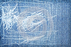 White thread sewing patterns patch on blue denim texture for background
