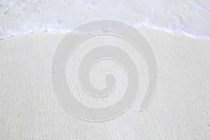 Close-up of white tropical beach with waves