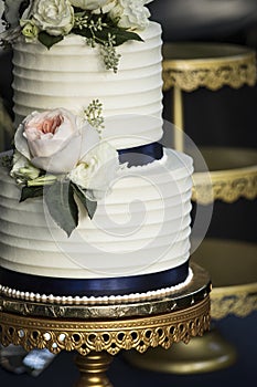 Close up of white two tiered wedding cake with flowers