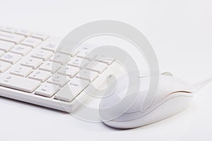 Close up of white wireless keyboard and wired mouse