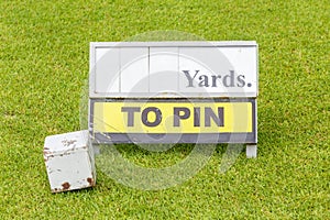 Close-up white wooden tee off area or tee box with length inform