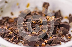 Close-up of white yogurt and pieces of brown chocolate, health f