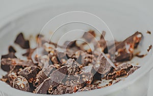 Close-up of white yogurt and pieces of brown chocolate, health f