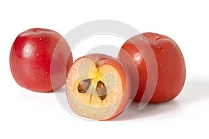 Close-up of whole and halves of a paradise apple berry with a peduncle on a white background. Full depth of field