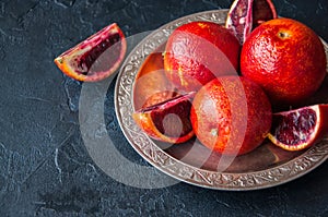 Close up of whole and slices of fresh and ripe blood oranges in