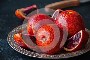 Close up of whole and slices of fresh and ripe blood oranges in