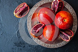 Close up of whole and slices of fresh and ripe blood oranges in