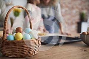 Close up of wicker basket full of Easter eggs
