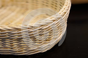 Close-up of a wicker basket on a white background. With shallow