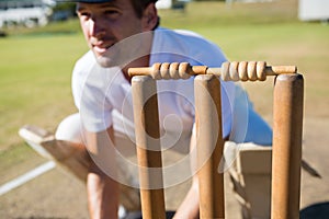 Close up of wicket keeper crouching by stumps
