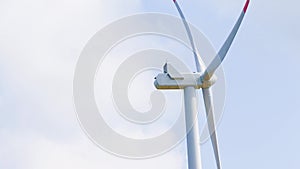 Close-up of wind energy turbine are one of the cleanest, renewable electric energy source, under blue sky
