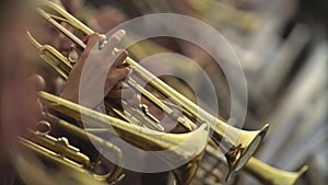 Close-up of wind instruments. Jazzman plays the trumpet. Brass tool.