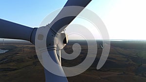 Close up of a wind turbine. Aerial top view wind turbine, moving above the white modern construction of the wind turbine