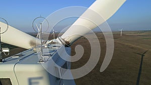 Close up of a wind turbine. Aerial top view wind turbine, moving above the white modern construction of the wind turbine