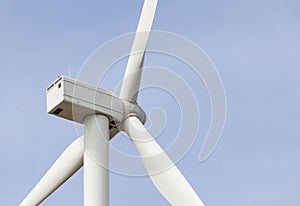 Close up wind turbine alternative energy with blue sky background